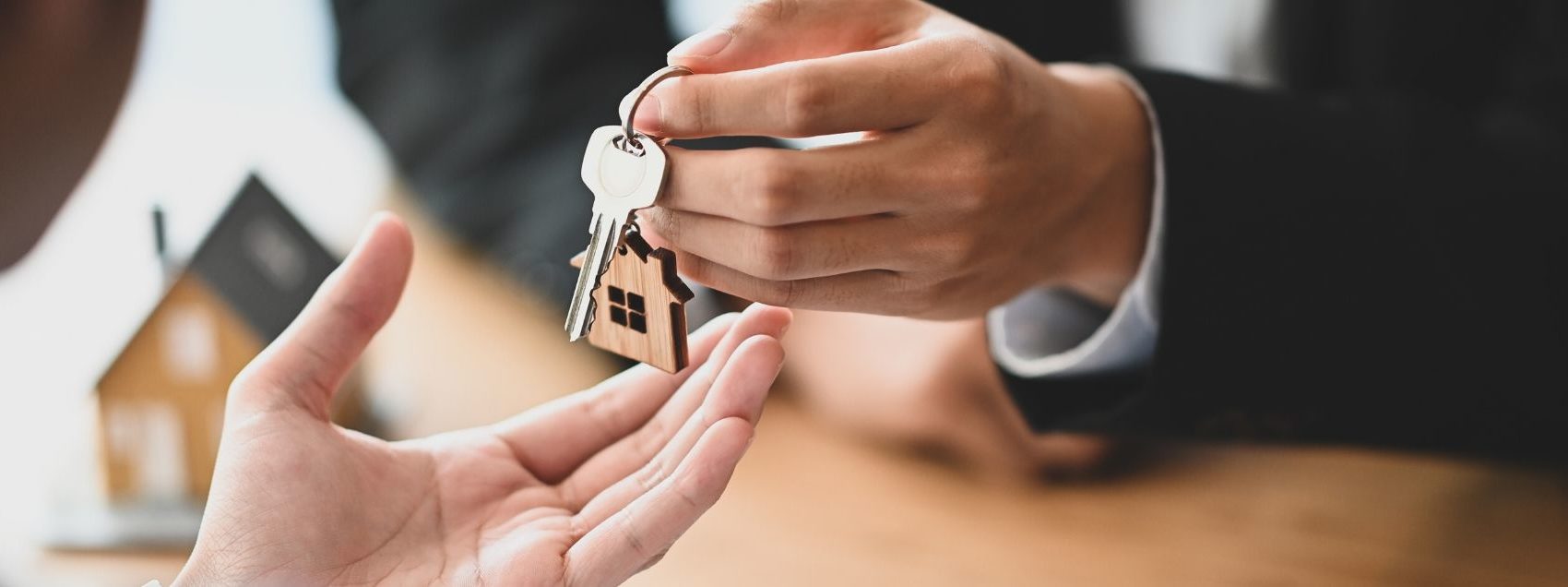 mortgage lender handing house keys to homeowner