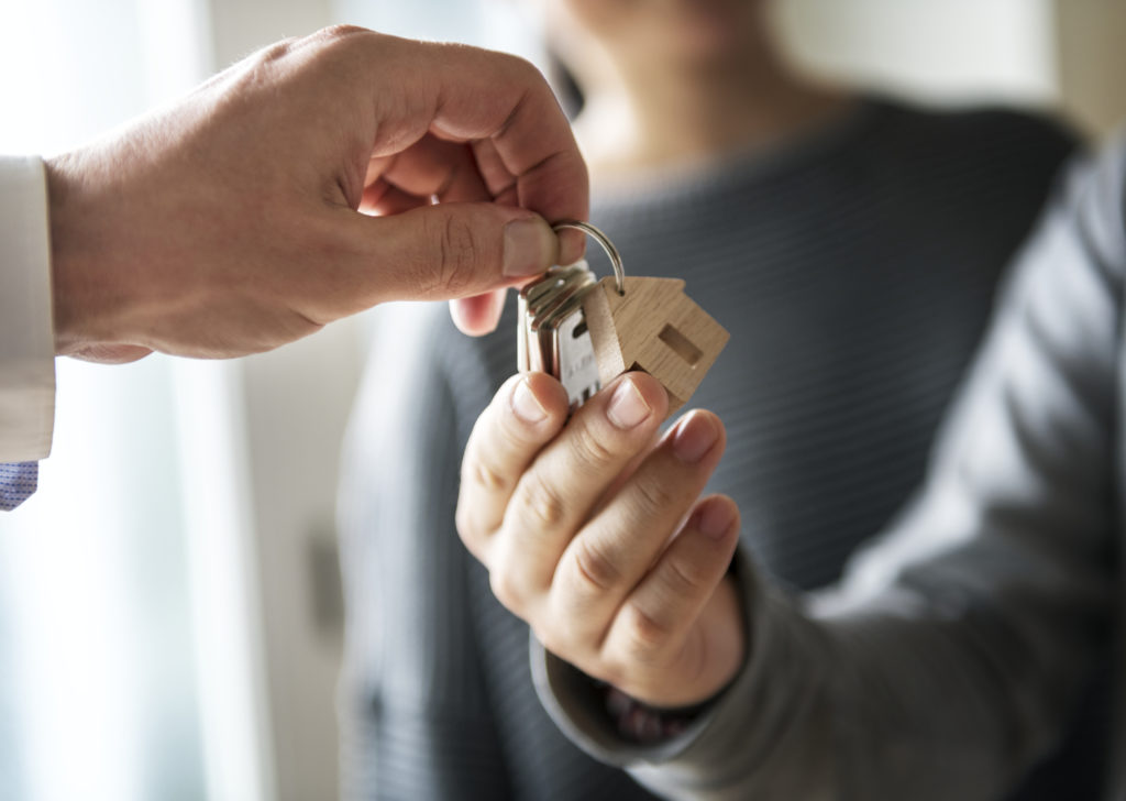agent handing over keys to new house