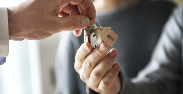 agent handing over keys to new house